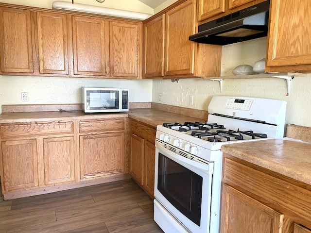 11729 Timber Heights Dr, Austin, TX 78754 - kitchen featuring gas range gas stove, stainless steel microwave, under cabinet range hood, dark wood-style floors, and brown cabinets