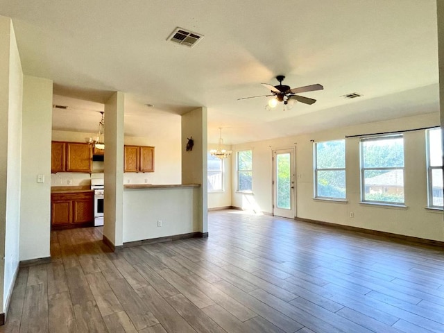 11729 Timber Heights Dr, Austin, TX 78754 - unfurnished living room featuring a chandelier, ceiling fan, and dark wood-type flooring