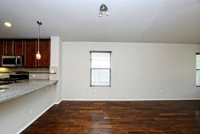 15628 Interlachen Dr, Austin, TX 78717 - kitchen featuring stainless steel appliances, dark wood finished floors, plenty of natural light, tasteful backsplash, and recessed lighting
