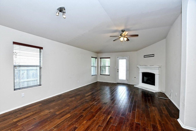 15628 Interlachen Dr, Austin, TX 78717 - unfurnished living room with ceiling fan, dark wood-style flooring, a fireplace with raised hearth, and vaulted ceiling