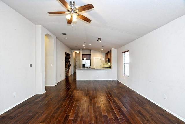 15628 Interlachen Dr, Austin, TX 78717 - unfurnished living room featuring vaulted ceiling, dark wood-style floors, arched walkways, and ceiling fan