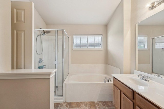 bathroom with healthy amount of natural light, a stall shower, and a bath