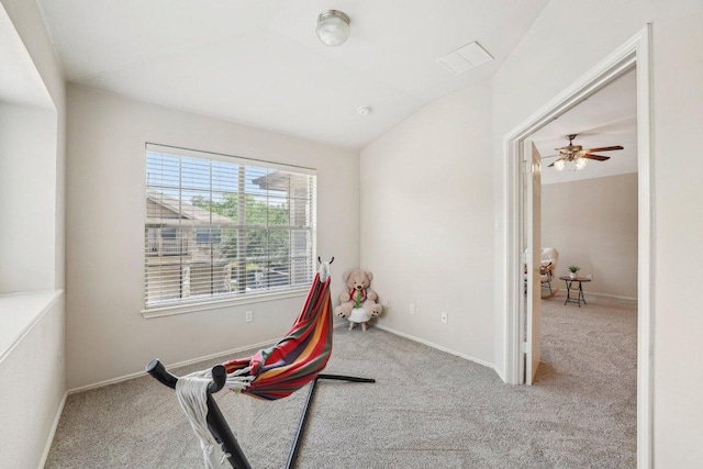 recreation room with carpet, vaulted ceiling, and baseboards