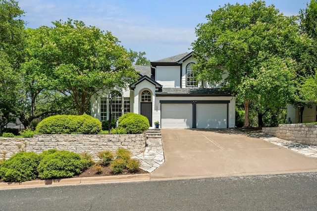view of front of house featuring an attached garage, stucco siding, and driveway