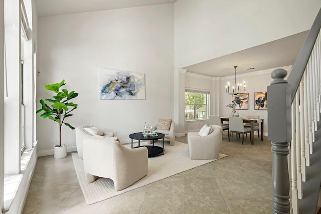 living room featuring a chandelier, stairs, baseboards, crown molding, and a high ceiling