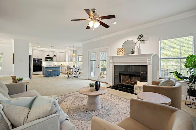 living area featuring ornamental molding, ceiling fan, a tile fireplace, baseboards, and recessed lighting