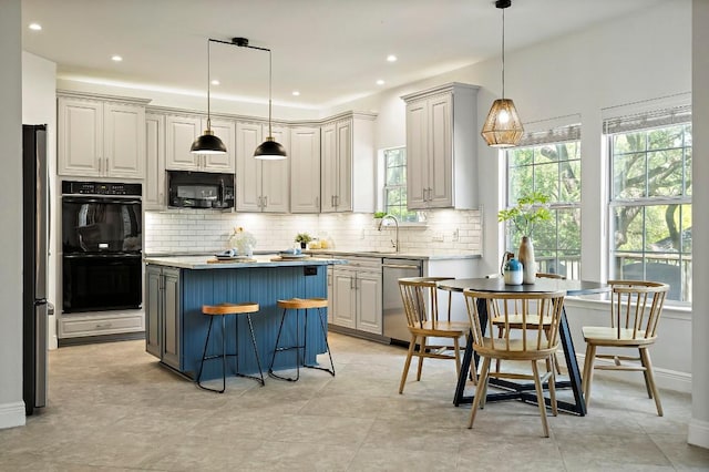 kitchen featuring black appliances, plenty of natural light, a sink, backsplash, and recessed lighting