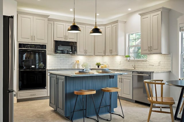 kitchen featuring black appliances, a sink, a center island, tasteful backsplash, and a kitchen breakfast bar