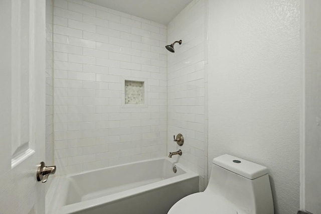 full bath with toilet, bathing tub / shower combination, and a textured wall