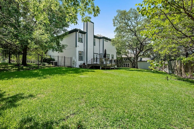 view of yard with a wooden deck and central AC