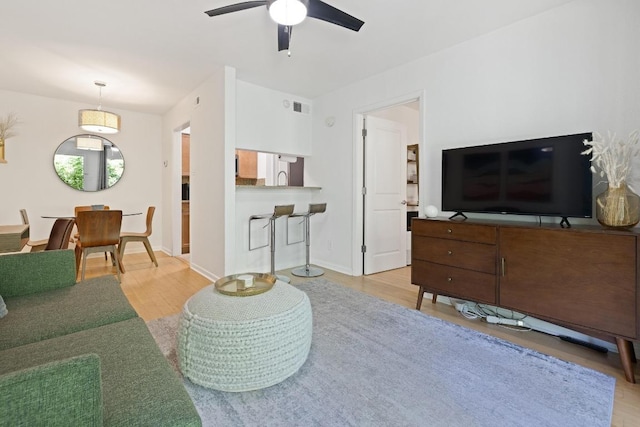 3204 Menchaca Rd Unit 716, Austin, TX 78704 - living area with wood finished floors, ceiling fan, and baseboards