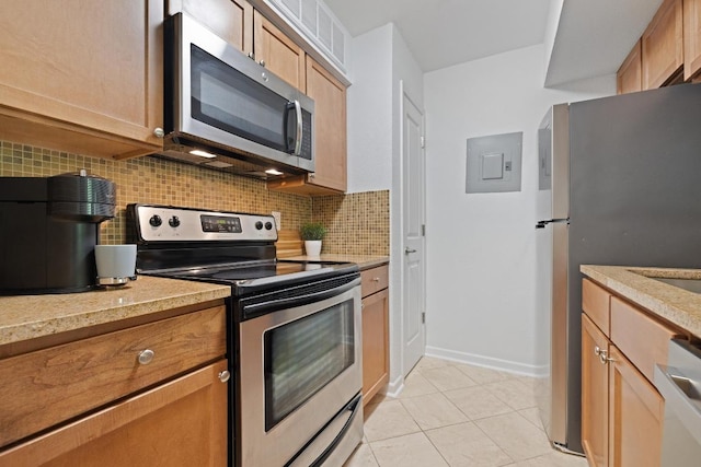 3204 Menchaca Rd Unit 716, Austin, TX 78704 - kitchen with stainless steel appliances, electric panel, backsplash, light tile patterned flooring, and light stone countertops