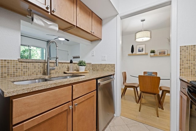 3204 Menchaca Rd Unit 716, Austin, TX 78704 - kitchen with stainless steel dishwasher, a sink, decorative backsplash, brown cabinets, and light stone countertops