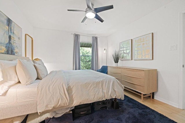 3204 Menchaca Rd Unit 716, Austin, TX 78704 - bedroom with wood finished floors, ceiling fan, and baseboards
