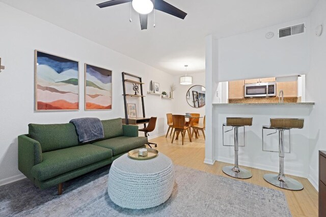 3204 Menchaca Rd Unit 716, Austin, TX 78704 - living area with light wood-style floors and a ceiling fan