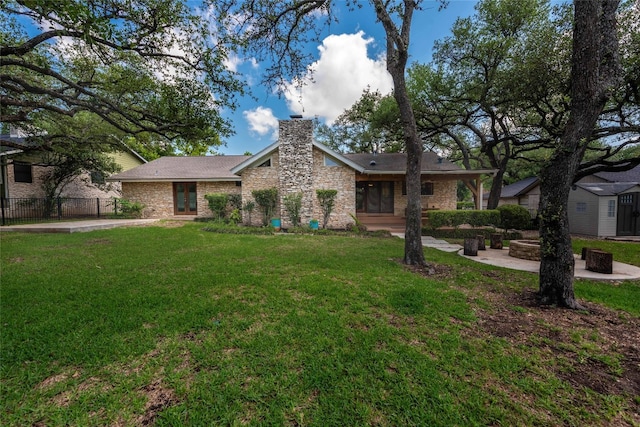 11532 Spicewood Pkwy, Austin, TX 78750 - view of front of house with a chimney and an outdoor fire pit
