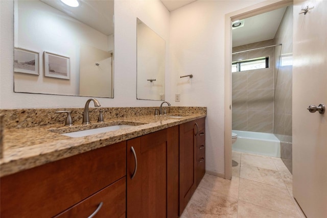 full bath featuring toilet, a shower, double vanity, and tile patterned flooring