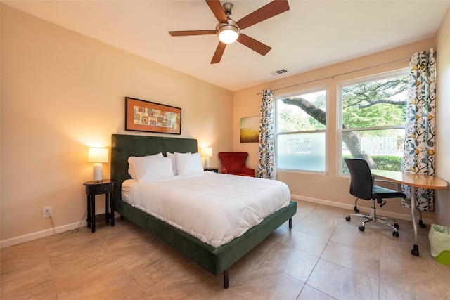 bedroom featuring baseboards, a desk, light tile patterned flooring, and ceiling fan