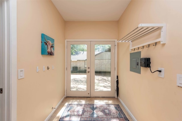doorway with french doors, electric panel, and baseboards