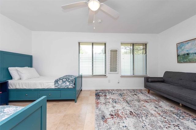 bedroom with baseboards, ceiling fan, and light tile patterned floors