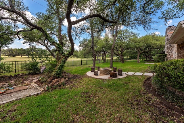 view of yard featuring a fire pit and a patio