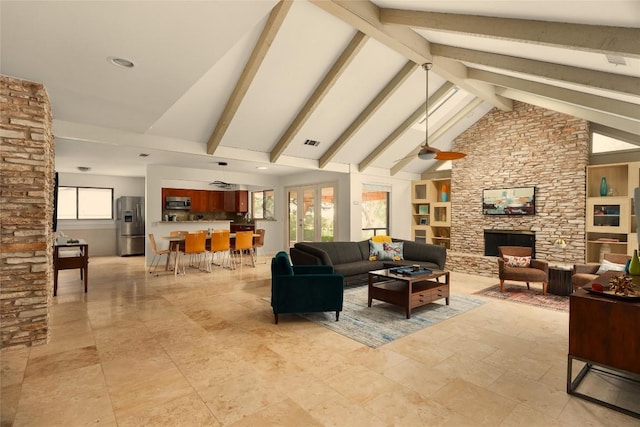 11532 Spicewood Pkwy, Austin, TX 78750 - living room with healthy amount of natural light, high vaulted ceiling, a fireplace, ceiling fan, and beamed ceiling