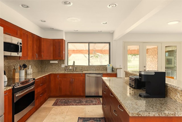 11532 Spicewood Pkwy, Austin, TX 78750 - kitchen with stainless steel appliances, light stone countertops, decorative backsplash, french doors, and recessed lighting