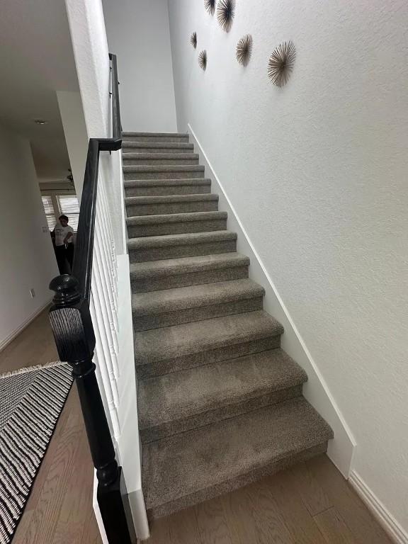 2050 Egret Ave, New Braunfels, TX 78132 - stairway featuring baseboards and wood finished floors