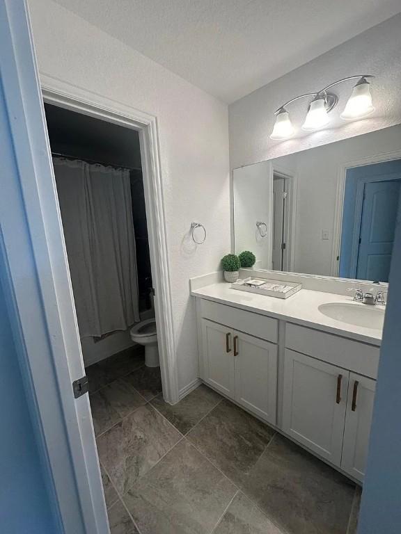 2050 Egret Ave, New Braunfels, TX 78132 - full bath with vanity, toilet, and a shower with curtain