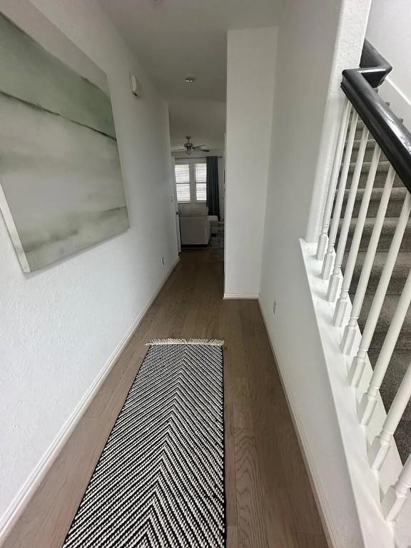 2050 Egret Ave, New Braunfels, TX 78132 - hallway with stairs, wood finished floors, and baseboards