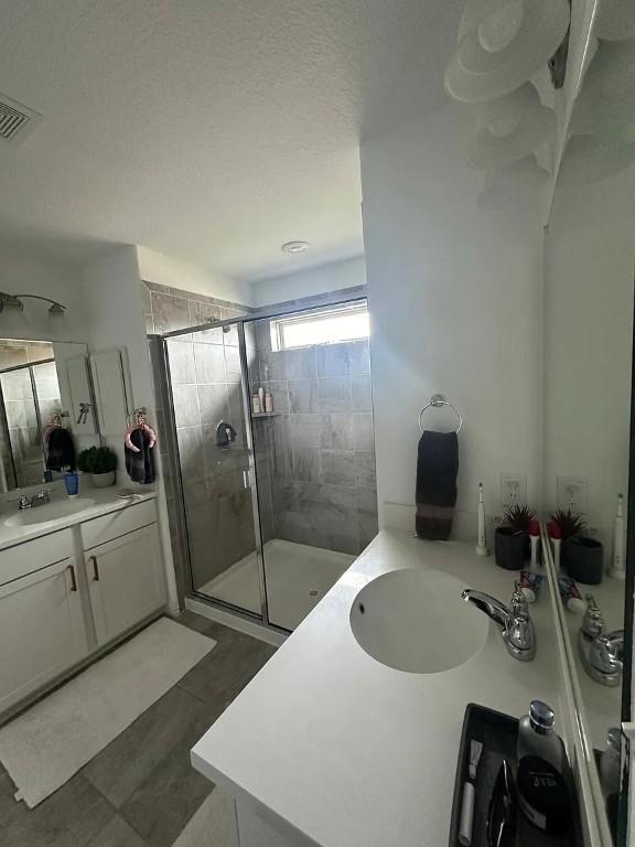 2050 Egret Ave, New Braunfels, TX 78132 - bathroom with a stall shower and vanity