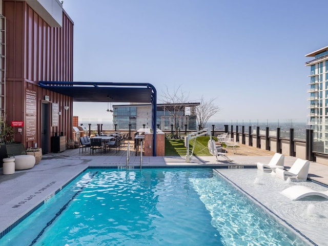 community pool featuring a water view and a patio area