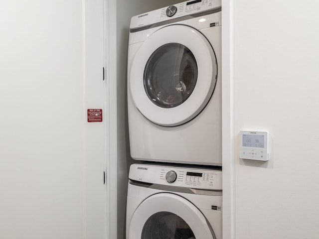 laundry room featuring stacked washer and clothes dryer