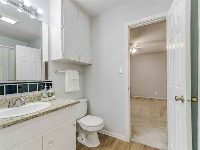 1912 Lightsey Rd Unit 1, Austin, TX 78704 - full bathroom featuring toilet, a ceiling fan, vanity, wood finished floors, and baseboards