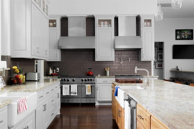 401 Rocky River Rd, West Lake Hills, TX 78746 - kitchen with wall chimney exhaust hood, double oven range, tasteful backsplash, and white cabinets