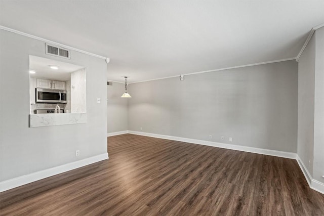 7920 Rockwood Ln Unit 104, Austin, TX 78757 - unfurnished living room featuring crown molding, dark wood-style floors, and baseboards