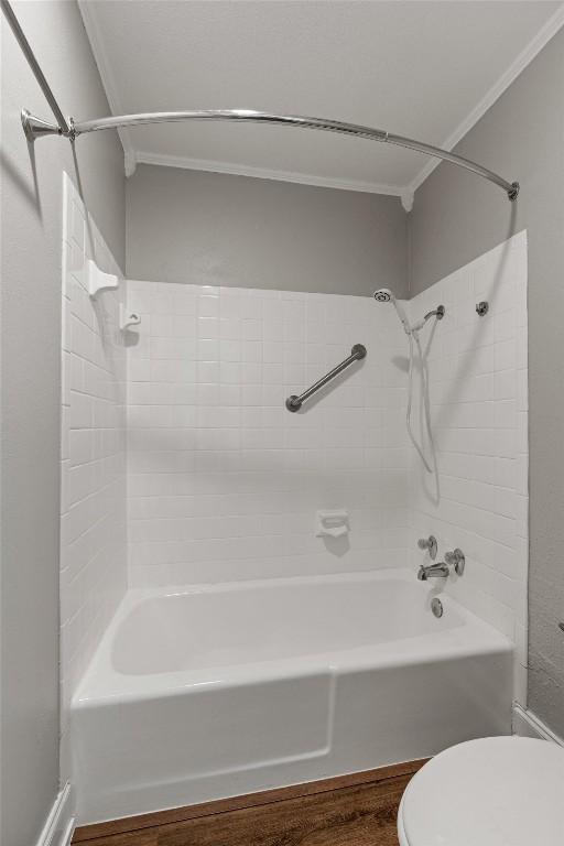 7920 Rockwood Ln Unit 104, Austin, TX 78757 - bathroom featuring toilet,  shower combination, and wood finished floors