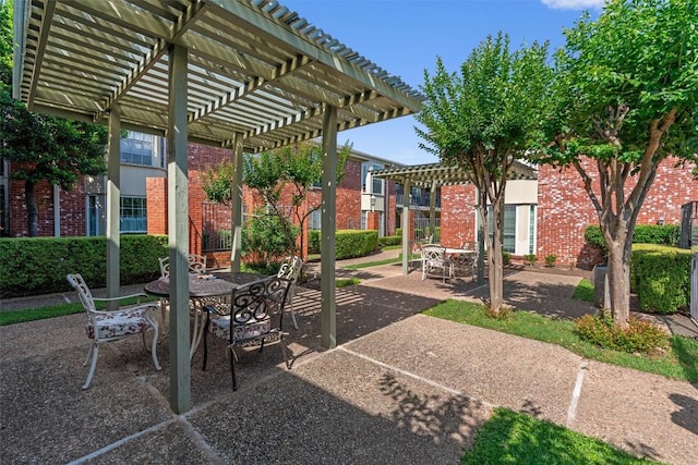 7920 Rockwood Ln Unit 104, Austin, TX 78757 - view of patio / terrace featuring a pergola and outdoor dining space