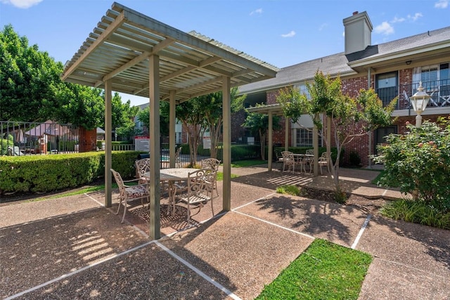 7920 Rockwood Ln Unit 104, Austin, TX 78757 - view of patio featuring outdoor dining area and a pergola