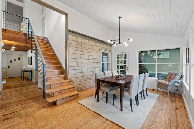 dining space with stairway, light wood-style flooring, a chandelier, wood ceiling, and high vaulted ceiling