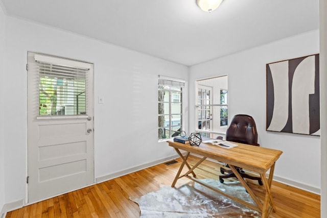 office area featuring light wood finished floors and baseboards