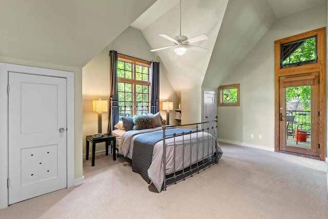 bedroom with carpet floors, baseboards, lofted ceiling, multiple windows, and access to exterior