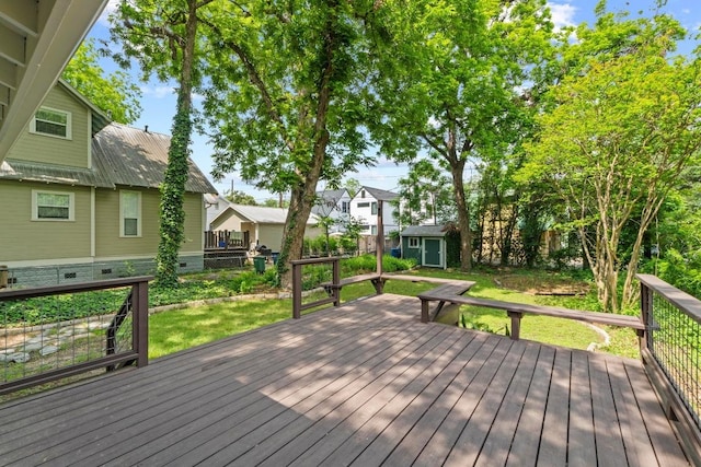 deck featuring a shed, an outdoor structure, and a residential view