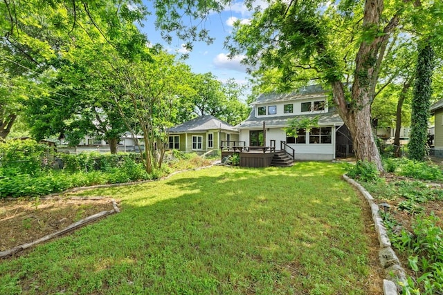 back of house featuring a deck and a yard