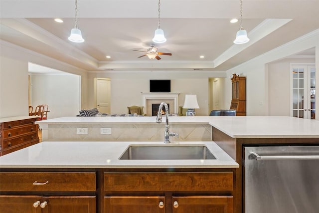 419 Davis Mountain Cir, Georgetown, TX 78633 - kitchen featuring dishwasher, a sink, a tray ceiling, open floor plan, and light countertops