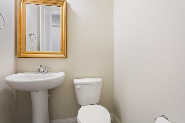 419 Davis Mountain Cir, Georgetown, TX 78633 - bathroom with toilet, baseboards, and a sink