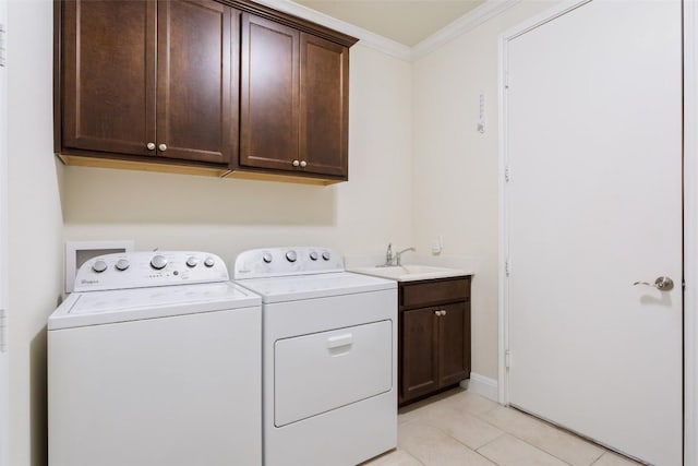 419 Davis Mountain Cir, Georgetown, TX 78633 - washroom featuring washer and clothes dryer, cabinet space, ornamental molding, and light tile patterned flooring