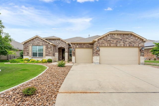 419 Davis Mountain Cir, Georgetown, TX 78633 - french provincial home featuring a garage, driveway, a front yard, brick siding, and a shingled roof