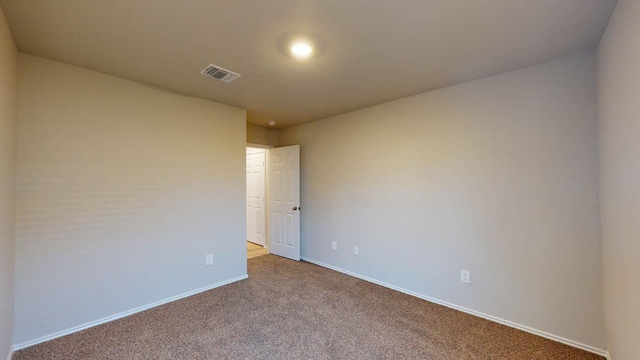 spare room with carpet floors and baseboards