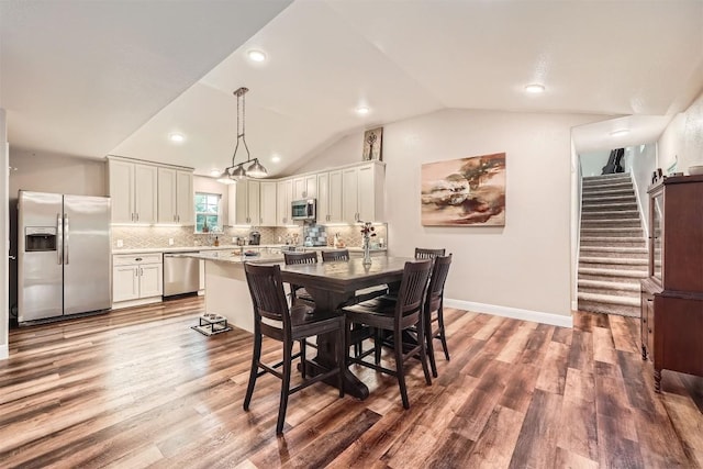 100 Comanche Trl, Georgetown, TX 78633 - dining area with wood finished floors, vaulted ceiling, recessed lighting, stairs, and baseboards